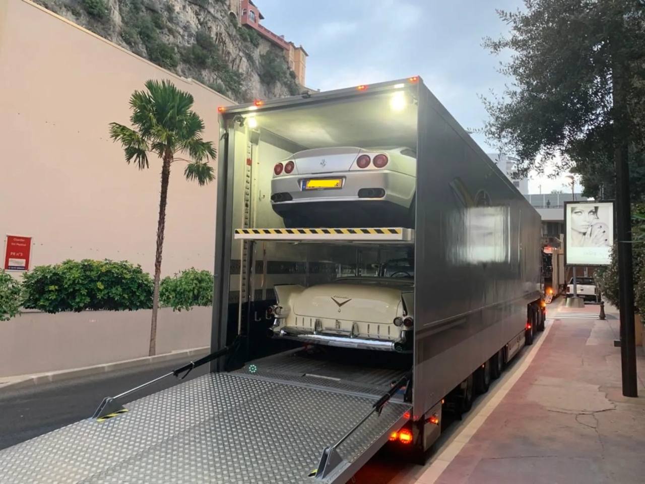 Two vehicles loaded in an enclosed multi-car carrier
